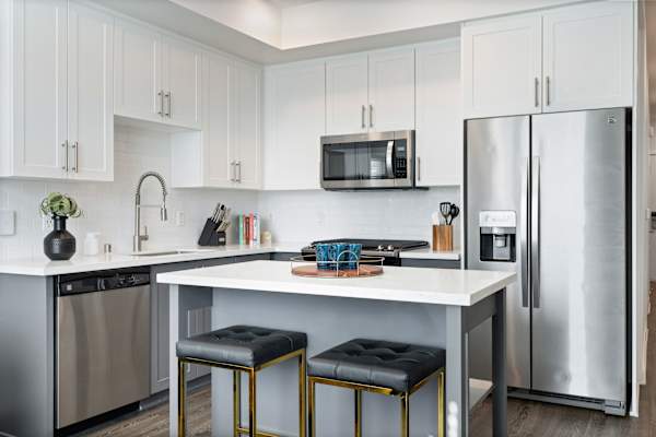 a kitchen with stainless steel appliances and a white counter top